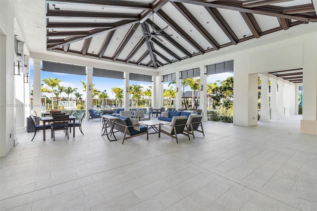 sunroom / solarium featuring a wealth of natural light and lofted ceiling with beams