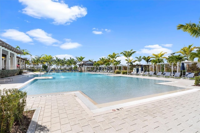 view of swimming pool featuring pool water feature and a patio