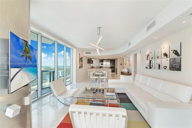 living room featuring a wall of windows