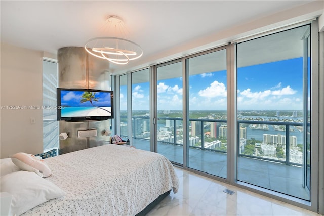 bedroom featuring access to outside, an inviting chandelier, and expansive windows