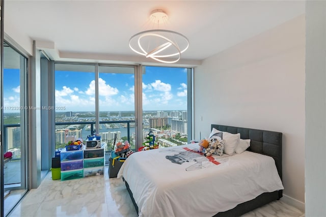 bedroom with access to outside, a wall of windows, and a water view