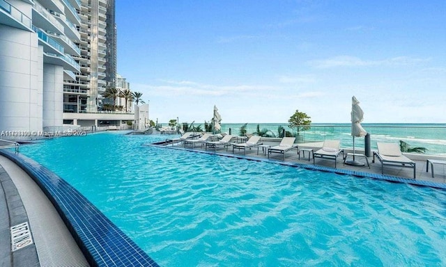 view of pool with a water view