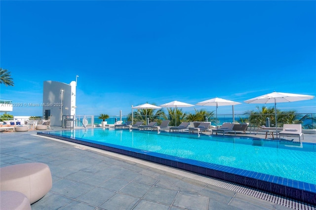 view of swimming pool featuring a mountain view and a patio