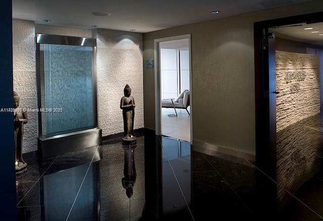 hall featuring dark tile patterned floors