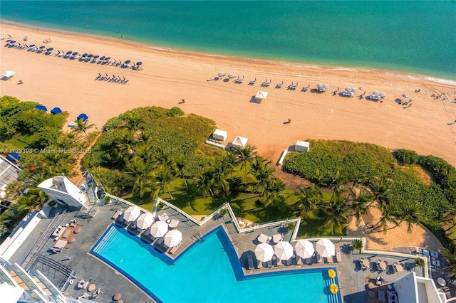 drone / aerial view featuring a beach view and a water view