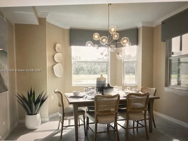 dining space with a notable chandelier and ornamental molding