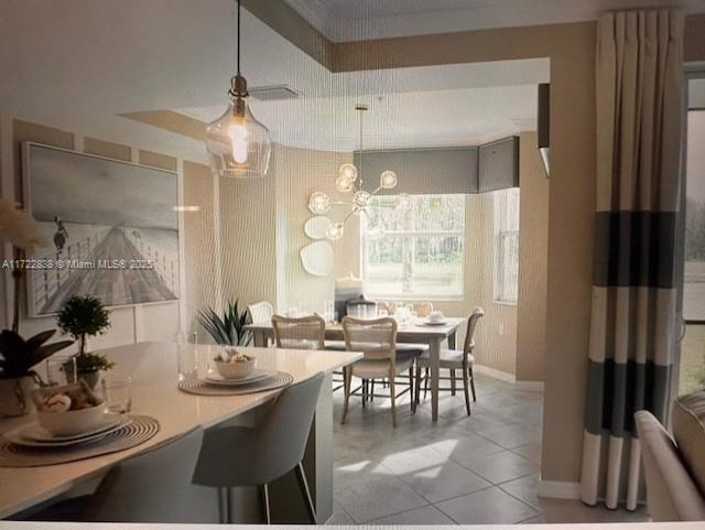 kitchen with sink, appliances with stainless steel finishes, pendant lighting, white cabinets, and ornamental molding