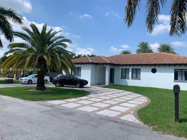 mediterranean / spanish-style home with a front lawn