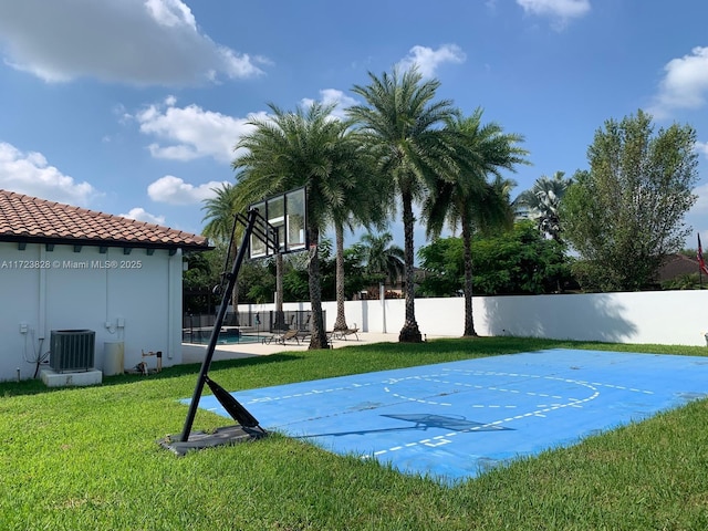 view of basketball court with a lawn