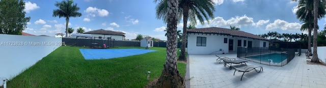 exterior space featuring a yard, a patio, and a storage shed