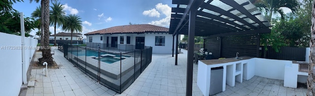 view of swimming pool with a patio area, a pergola, and an in ground hot tub