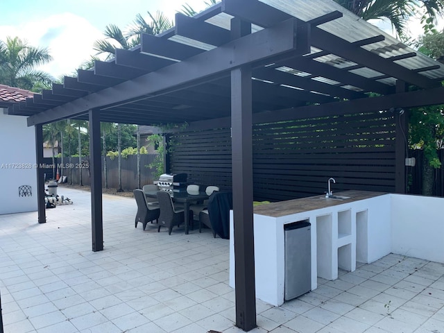 view of patio with a bar and a pergola