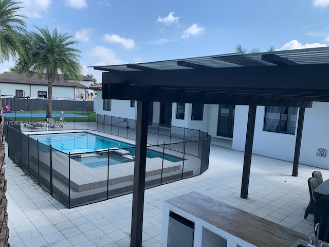 view of swimming pool with an in ground hot tub and a patio