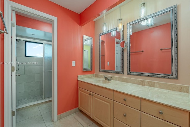 bathroom with tile patterned flooring, vanity, and an enclosed shower