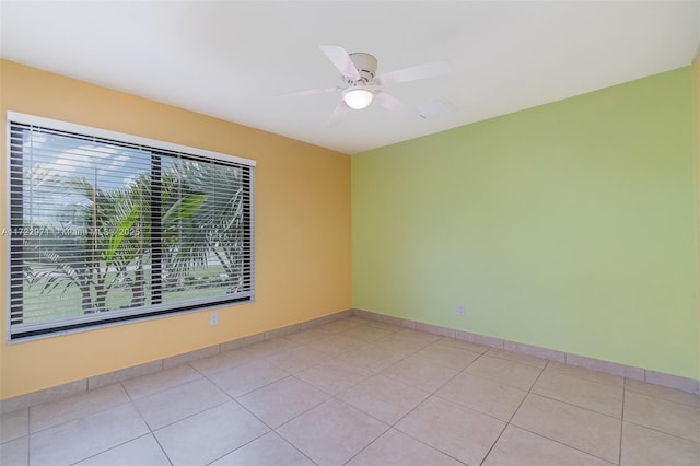 tiled empty room featuring plenty of natural light and ceiling fan