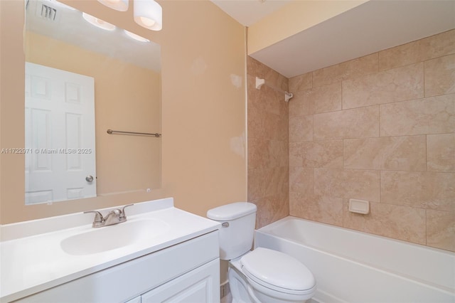 full bathroom featuring vanity, toilet, and tiled shower / bath