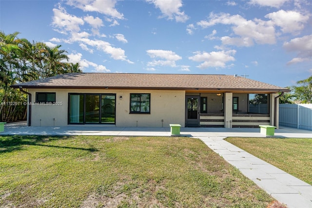 back of house with a lawn and a patio area