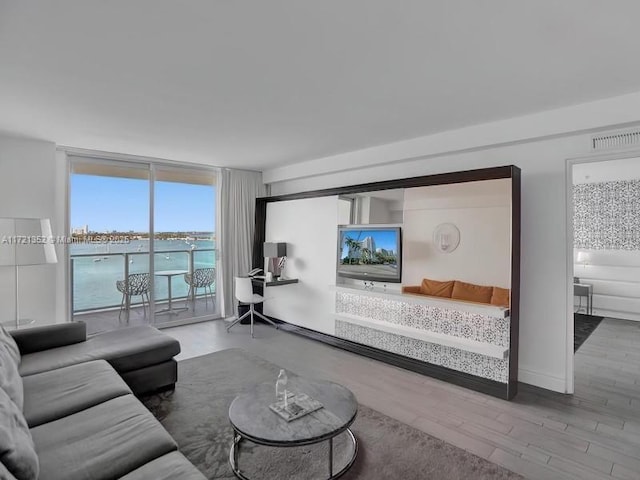 living room with floor to ceiling windows and wood-type flooring