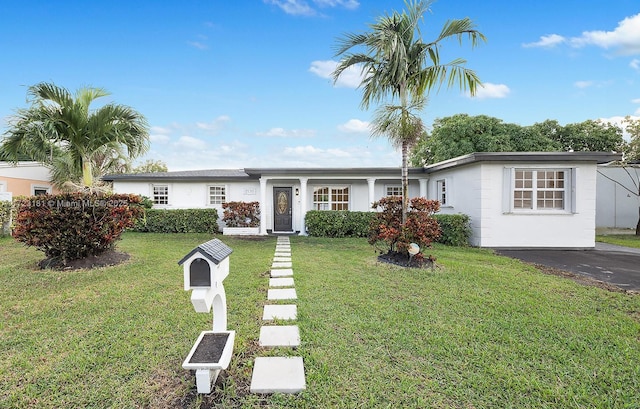 ranch-style home featuring a front yard