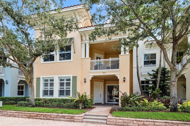 view of front of property featuring a tile roof and stucco siding