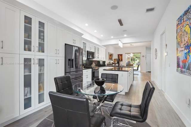 dining room with light hardwood / wood-style flooring