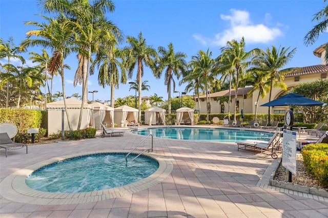 pool with a patio and fence