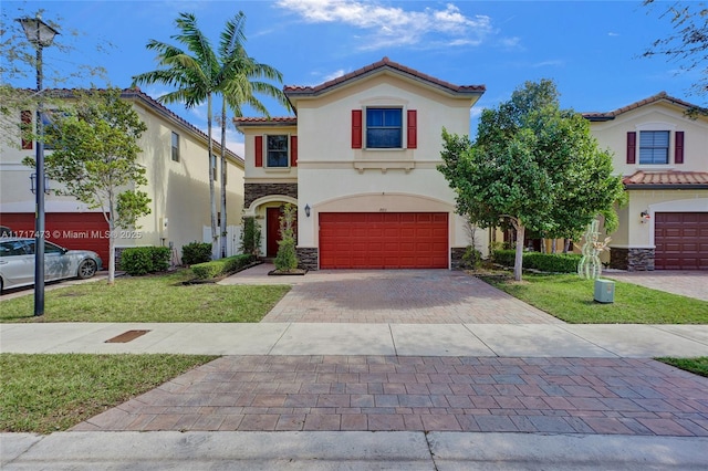 mediterranean / spanish-style home featuring a garage and a front yard