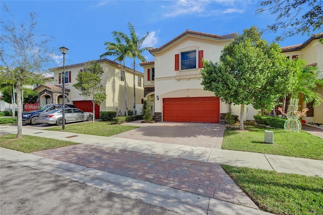 mediterranean / spanish-style home featuring a garage and a front yard