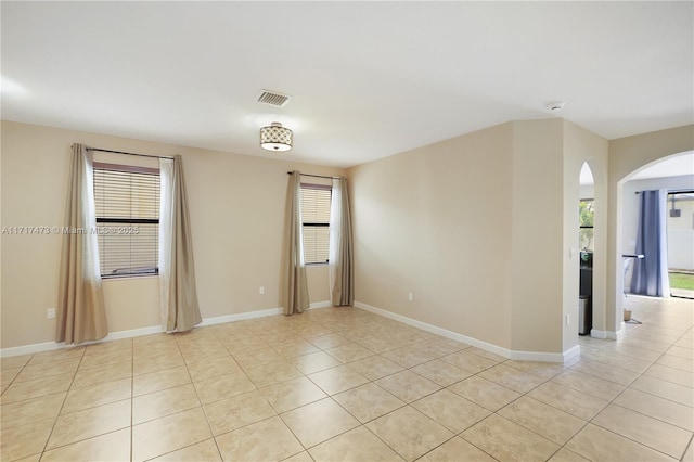 tiled empty room featuring a wealth of natural light