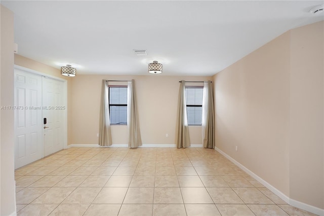 spare room featuring light tile patterned floors