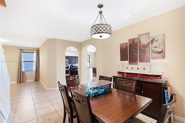 dining area featuring light tile patterned flooring