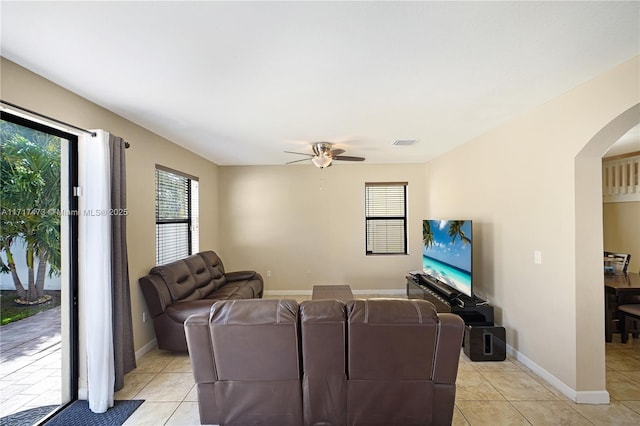 living room featuring light tile patterned flooring and ceiling fan