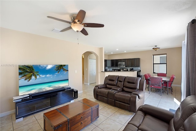 living room featuring light tile patterned flooring and ceiling fan