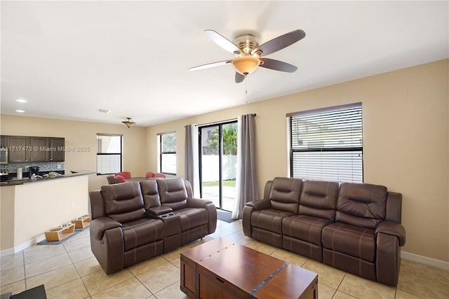 tiled living room featuring ceiling fan