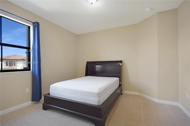 bedroom featuring light carpet