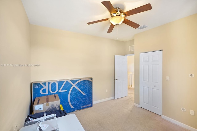 office space with ceiling fan and light colored carpet