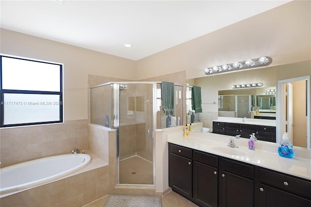 bathroom with independent shower and bath, vanity, and tile patterned flooring