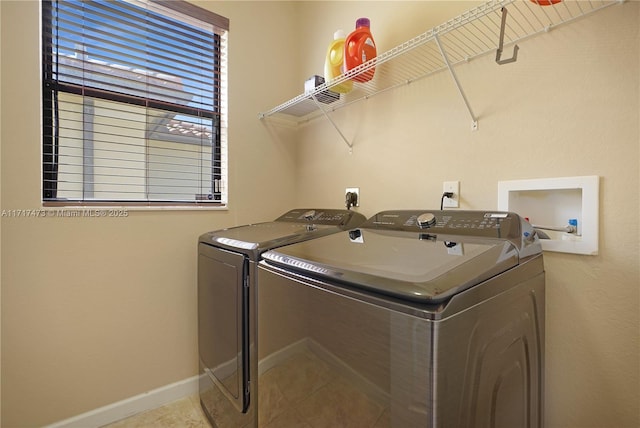 laundry room featuring washer and dryer and light tile patterned floors