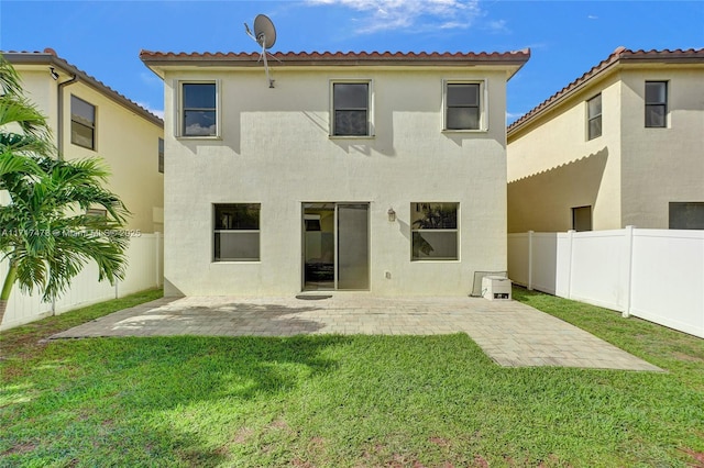 rear view of property with a patio area and a lawn