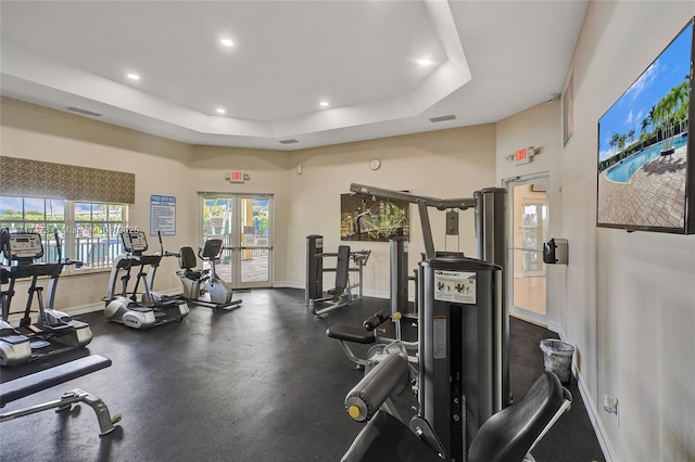 gym featuring a tray ceiling