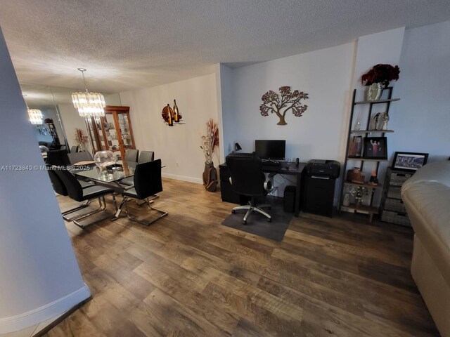 office area with hardwood / wood-style flooring, a textured ceiling, and an inviting chandelier