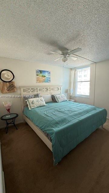 bedroom featuring dark carpet, a textured ceiling, and ceiling fan