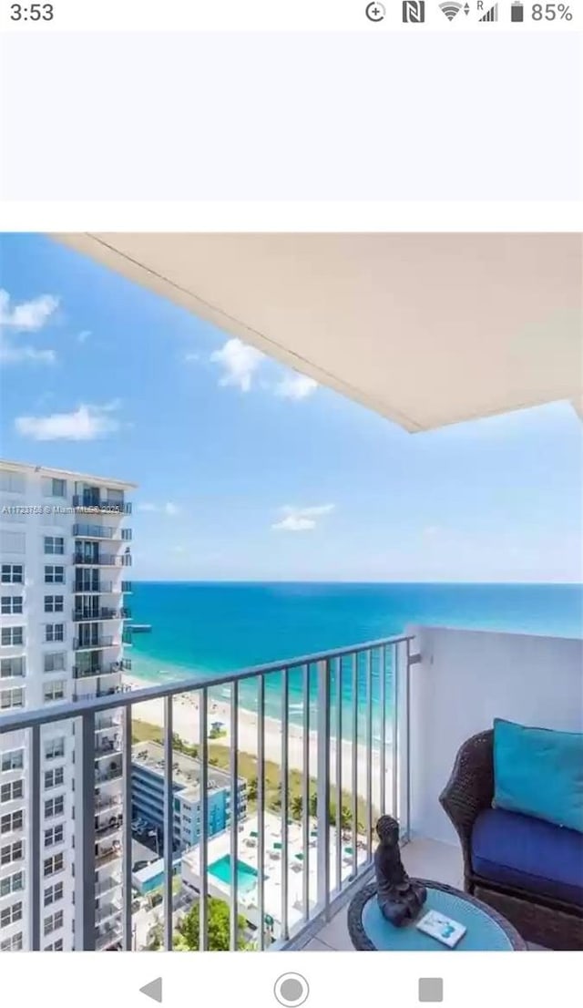 balcony with a view of the beach and a water view