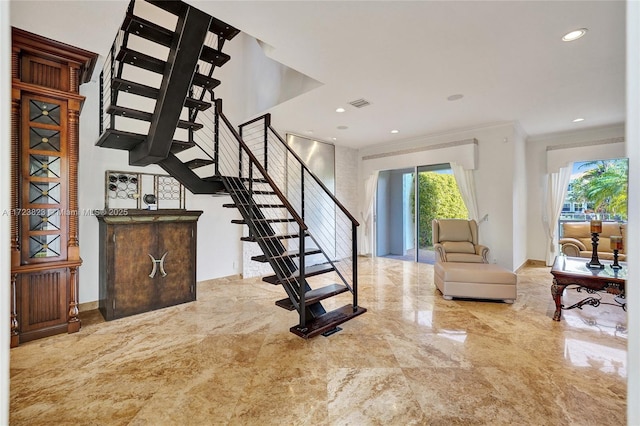 stairs featuring crown molding