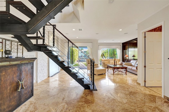 staircase featuring ornamental molding