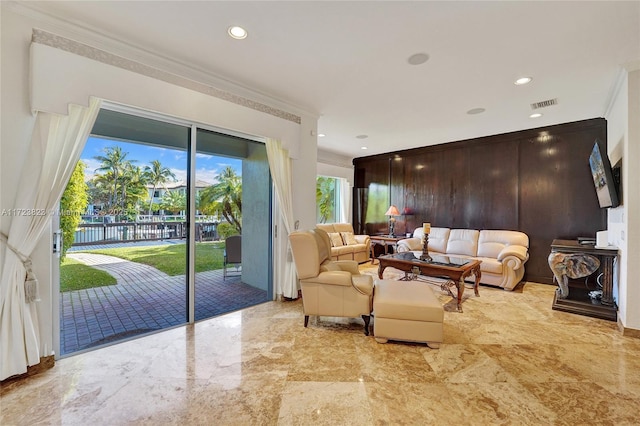 living room with ornamental molding and wooden walls