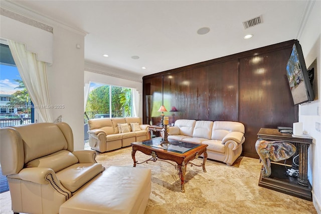 living room featuring plenty of natural light and ornamental molding