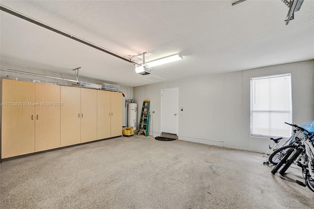 garage featuring electric water heater and a garage door opener