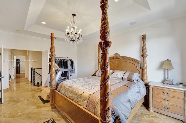 bedroom with a tray ceiling, crown molding, and a notable chandelier