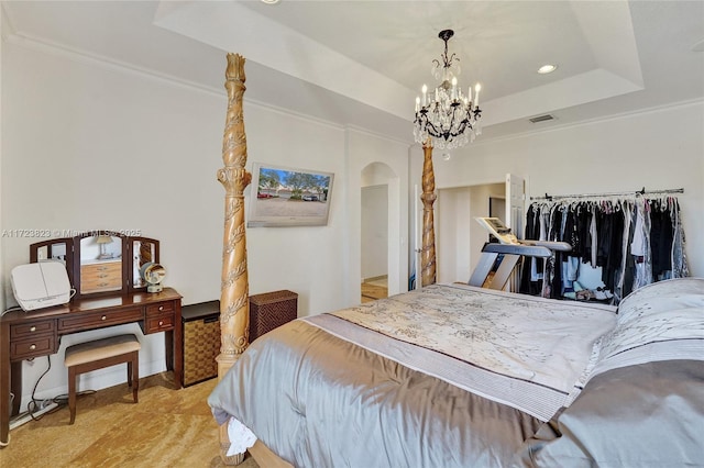 bedroom featuring a tray ceiling, a chandelier, and ornamental molding